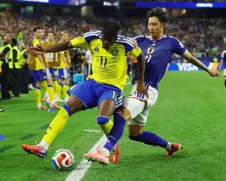 Sweden's Anthony Elanga holds off Japan's Hiroki Ito