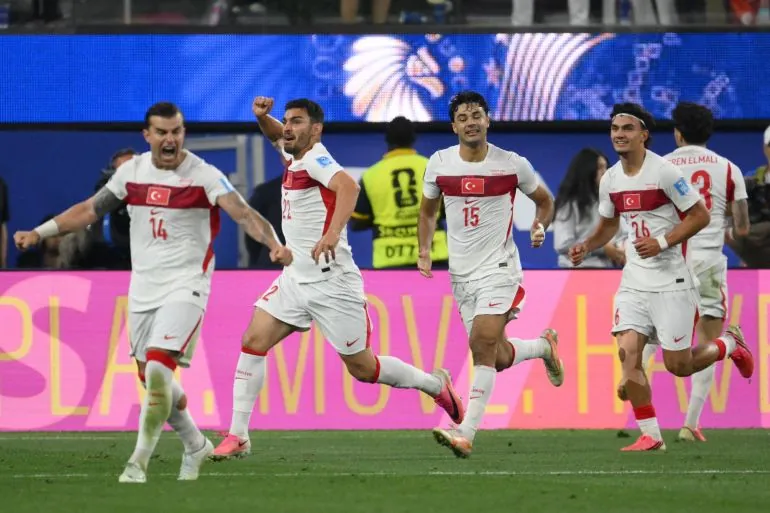 Turkey's defender #22 Kaan Ayhan (2nd L) celebrates after scoring his teams third goal during the 2026 World Cup Group D football match between Turkey and USA at the Los Angeles Stadium in Inglewood on June 25, 2026. (Photo by Patrick T. FALLON / AFP)