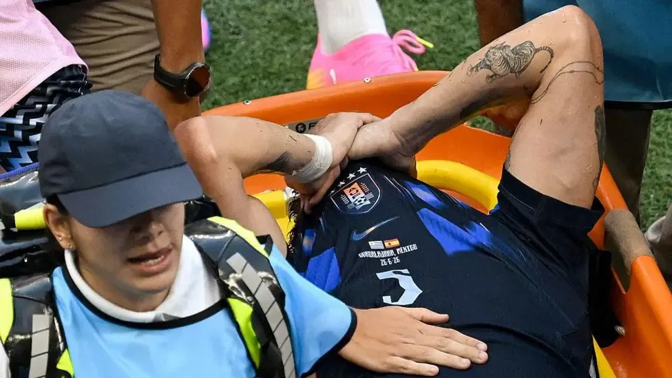 Manuel Ugarte leaves the pitch after being injured during the 2026 World Cup Group H football match between Uruguay and Spain