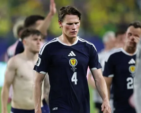 Scott McTominay walks off the pitch after defeat against Brazil.