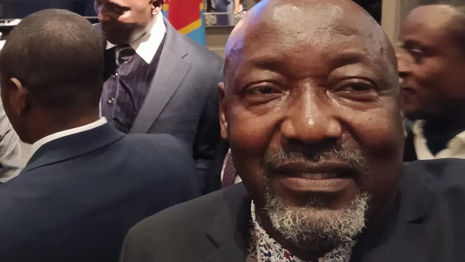 Supplied Jacques takes a selfie in a crowded room. He is smiling and is wearing a suit. He is bald and has a silver stuble.