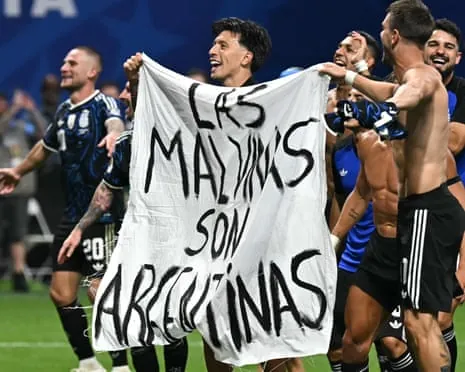 Argentina players hold a banner reading 'The Malvinas son Argentinas' after winning the World Cup semi-final against England in Atlanta.