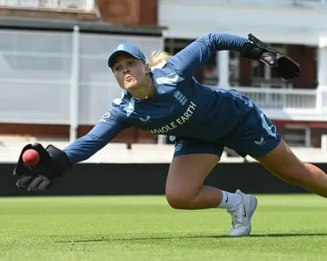 Eleanor Threlkeld dives to catch a ball during an England nets session