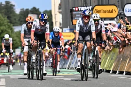 Tom Pidcock (second left) grimaces as he crosses the line but his efforts take him up to fourth in the GC
