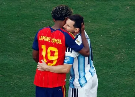 Lionel Messi hugs Lamine Yamal.