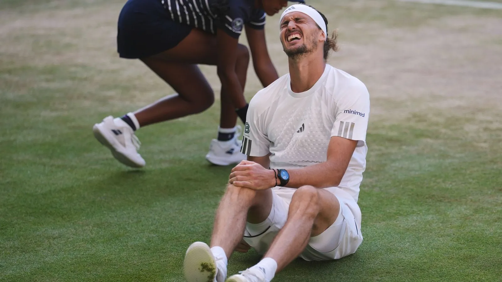 Alexander Zverev of Germany reacts after falling over during a point against Jannik Sinner of Italy in the men's singles final at Wimbledon Tennis Championships in London, Sunday, July 12, 2026. (AP Photo/Kirsty Wigglesworth)