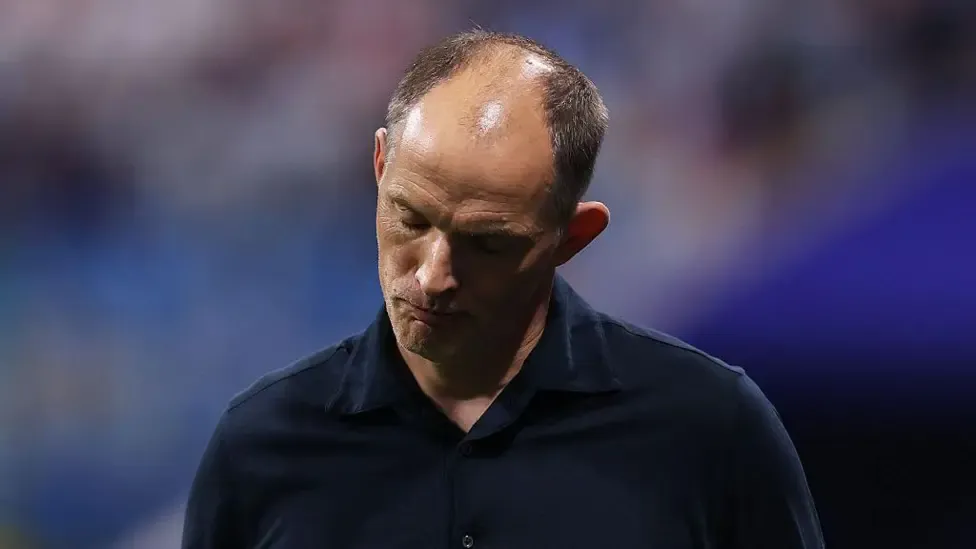 Thomas Tuchel, manager of England, bows his head during the FIFA World Cup 2026 semi-final match between England and Argentina
