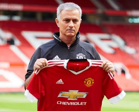 José Mourinho holds up a Manchester United shirt after being unveiled as manager in 2016